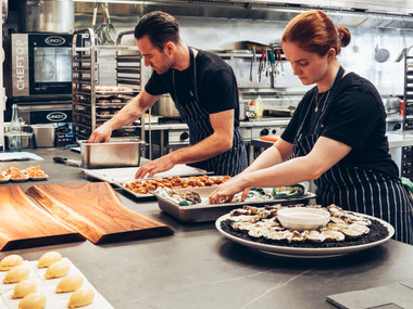 man-and-woman-wearing-black-and-white-striped-aprons-2696064.jpg